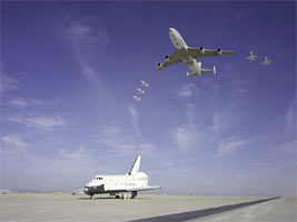 The NASA 747 carrier aircraft and five T-38 aircraft flew over the Space Shuttle Orbiter 101 �Enterprise� while it was parked on the runway at Edwards Air Force Base.