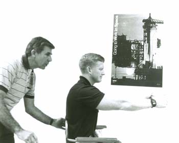 S84-37642.jpg - Mike Fox spinning astronaut candidate William Shepherd on Barany chair in Building 41 (1984) 