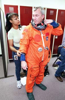 McDougle suiting up Terry Wilcutt for an astronaut crew training event at Building 9.