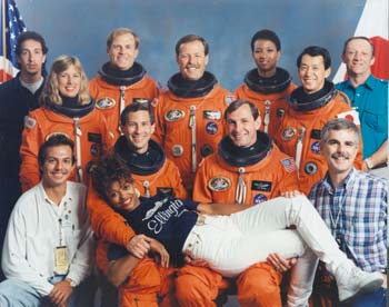 Having fun at the STS-47 crew photo shoot. Pictured l to r front row: Ray Villalobos, Jay Apt, Curt Brown, John Hopkins, McDougle lying across the front. Back row: Craig Carone, Jan Davis, Mark Lee, Hoot Gibson, Mae Jemison, Mamoru Mohri