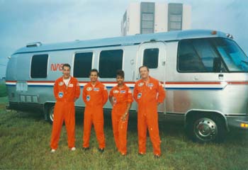 CEE Suit Technicians waiting in front of the Astro van for STS-47 to launch. Pictured l to r: Craig Carone, Ray Villalobos, McDougle, and Bill Todd.