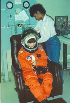 McDougle performing manned suit testing on STS-37 Mission Specialist Linda Godwin at KSC. This was McDougle's first assigned mission