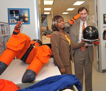 Congressman Pete Olson visits USA/FCE. McDougle briefed him on the suit and he tried on a glove