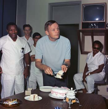 Astronaut Neil Armstrong serving his birthday cake in the Lunar Receiving Laboratory Crew Reception Area after the Apollo 11 mission.