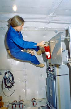 Astronaut Marsha Ivins on the KC-135 performing a Zero G evaluation of orbiter fire extinguishers.
