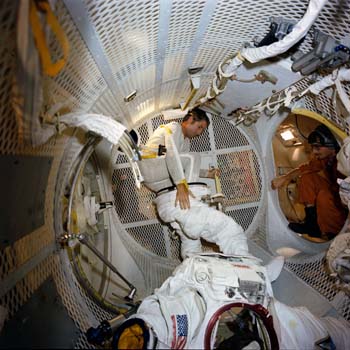 Astronaut Dick Truly testing EVA spacesuit don and duff activities during a KC-135 Zero G flight.