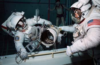 Underwater EVA Simulation of "Flyswatter" attachment in the Weightless Environment Training Facility (WETF) prior to the STS 51-D mission in April 1985.