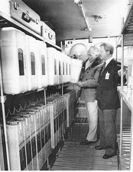 (Photo and caption appeared in Society of Photographic Science and Engineering Journal, October 1987) Frank Zehentner (left) and Terry Slezak prepare to remove an aluminum case containing rolls of original color film from the primary NASA humidity-controlled cold storage vault built for the permanent preservation of spaceflight films.  This is one of the two vaults maintained at O°F (-18°C) and 20% RH located at the NASA facility in Houston, Texas; the other vault, situated in a remote corner of the NASA property, is used to store a complete duplicate set of the films, together with written documentation.  A third NASA vault at the White Sands Missile Range in New Mexico, which also operates at 0°F (-18°C) and 20% RH, houses a second duplicate set of backup copies and documentation of the spaceflight films. 