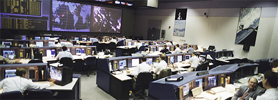 An overall view from the rear shows activity in the new Mission Control Center, opened for operation and dedicated during the STS-70 space shuttle mission.