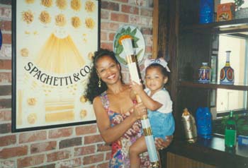 STS-78 landing party. McDougle with daughter Dominique McDougle, holding the Olympic Torch which flew aboard Columbia. 