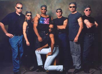 Photo shoot with the STS-98 crew. A safety poster was made from this photo (crew only). McDougle in front, standing l to r are: Valle Kauniste (suit tech), Marsha Ivins, Robert Curbeam, Commander Ken Cockrell, Mark Polansky, Tom Jones. 
