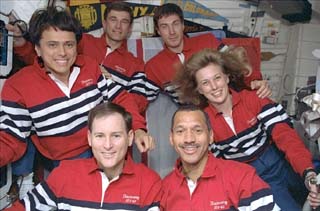 Crew portrait with school pennants in the background