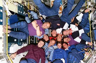 Inside the Spacelab Science Module, the crew members of STS-71, Mir 18 and Mir 19  pose for the traditional inflight portrait.