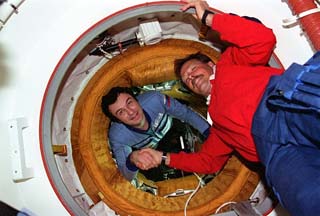 STS-71 Commander Robert "Hoot" Gibson and Mir 18 Commander Vladimir Dezhurov exchange greetings shortly after the first Shuttle-Mir docking
