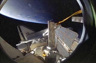 Shuttle port wing and payload bay door as seen from the Mir space station Base Block