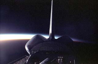 View of the STS-86 orbiter Atlantis's tail and payload bay during a sunrise