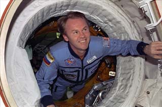 Thomas floats through the DM hatch into the shuttle airlock