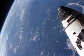 Shuttle and Earth as seen from Mir