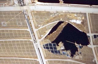 The damaged Spektr solar array, viewed from a window on the Mir
