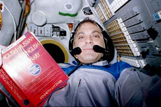 Astronaut David Wolf with a Russian-English dictionary.